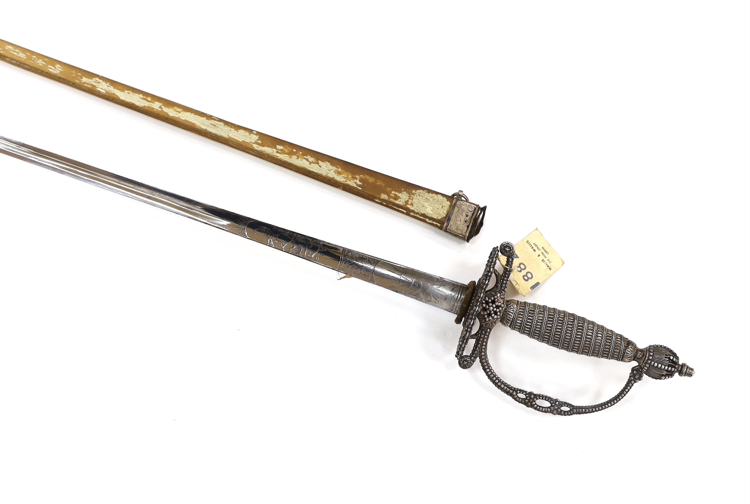 An English small sword, c.1775, pierced with facetted stud work, silver tape and wire bound grip, triangular section etched blade, in its original vellum scabbard and silver mounts, top mount engraved Dieltry Royal Excha